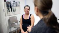 Patient speaks with doctor in exam room
